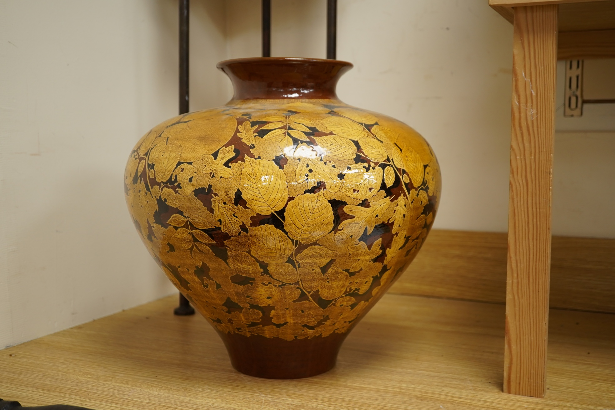 A large terracotta foliaiate decorated vase, 38cm high